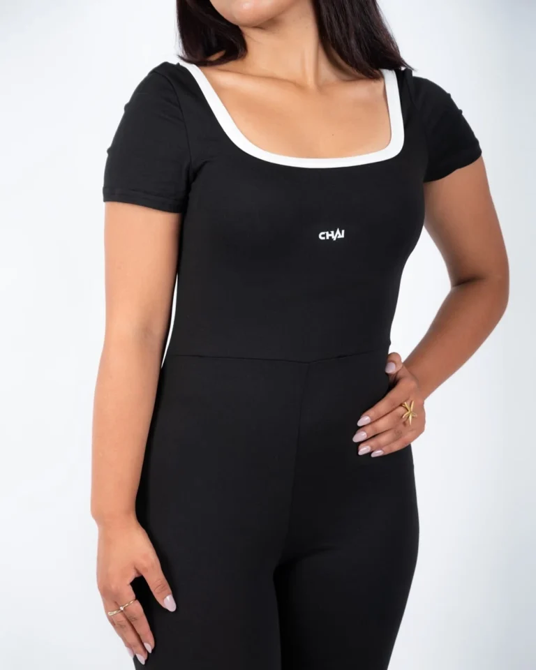 Black open back flare jumpsuit, close-up of the white neckline trim